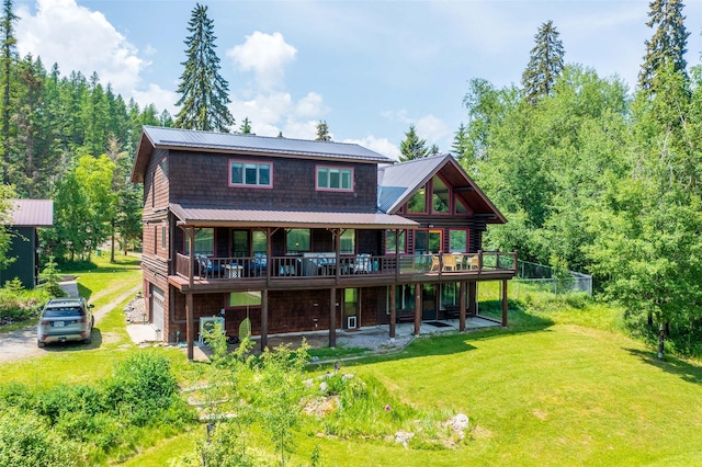 2755 US Highway 93 W, Whitefish, MT 59937 - rear view of property with a yard, a deck, a metal roof, and driveway