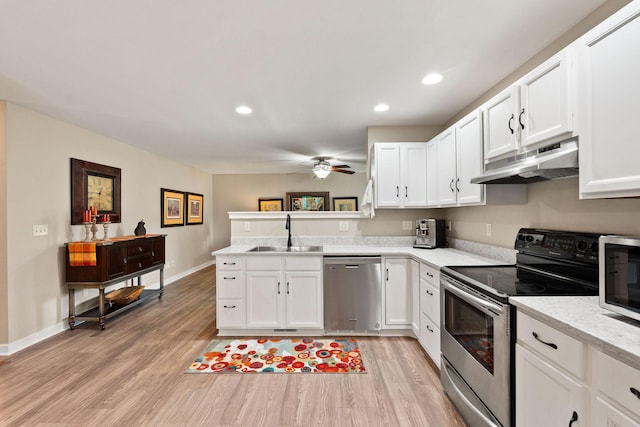 64 Empire Loop, Kalispell, MT 59901 - kitchen with stainless steel appliances, under cabinet range hood, a ceiling fan, light wood-style flooring, and recessed lighting