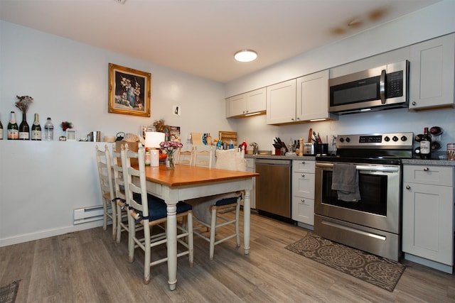 504 N 19th Ave, Bozeman, MT 59718 - kitchen featuring appliances with stainless steel finishes, light wood-style floors, and a baseboard radiator