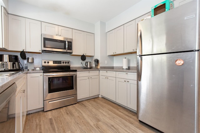 504 N 19th Ave, Bozeman, MT 59718 - kitchen featuring appliances with stainless steel finishes, light wood finished floors, and white cabinets