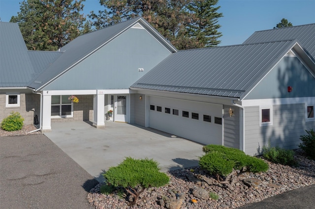 37B Stoney Brook Dr, Clancy, MT 59634 - view of side of property featuring a garage, a metal roof, and concrete driveway