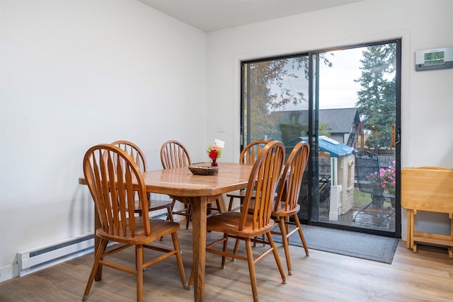609 11th Ave E, Polson, MT 59860 - dining area featuring a baseboard radiator and light wood finished floors
