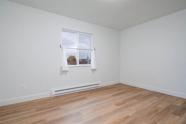 609 11th Ave E, Polson, MT 59860 - spare room featuring a baseboard heating unit and light wood-type flooring
