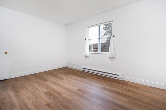 609 11th Ave E, Polson, MT 59860 - spare room with a baseboard heating unit and wood finished floors