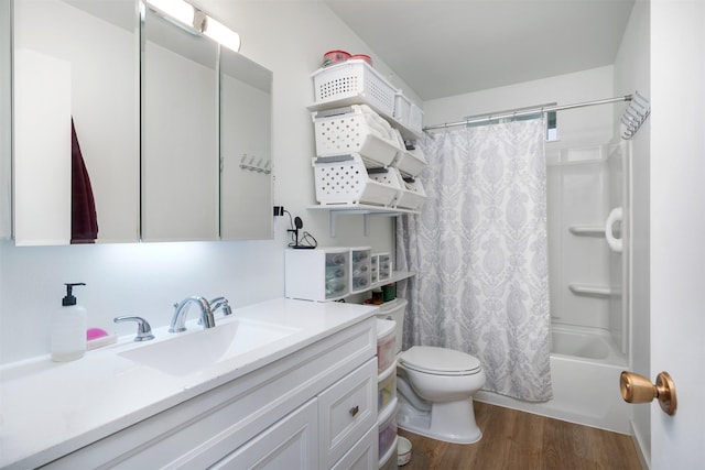 609 11th Ave E, Polson, MT 59860 - full bath featuring vanity, wood finished floors, and shower / bath combo with shower curtain