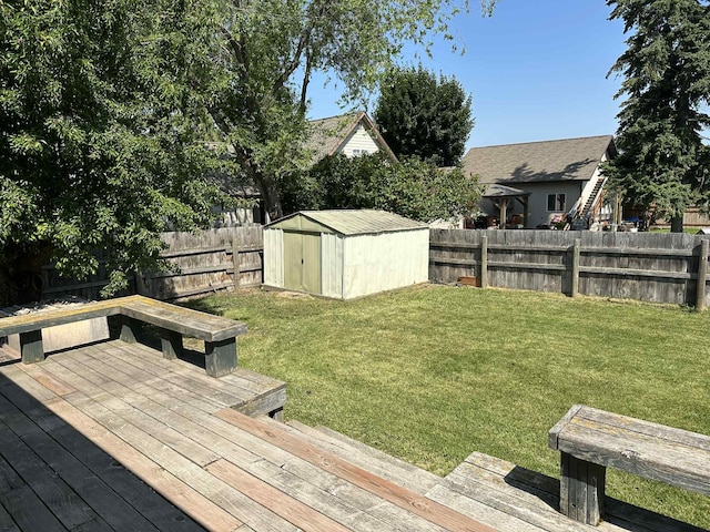 609 11th Ave E, Polson, MT 59860 - wooden terrace featuring a fenced backyard and a storage unit