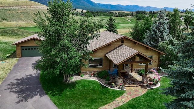 192 Leonard Ln, Eureka, MT 59917 - view of front of home with a mountain view, roof with shingles, stone siding, a porch, and a front yard