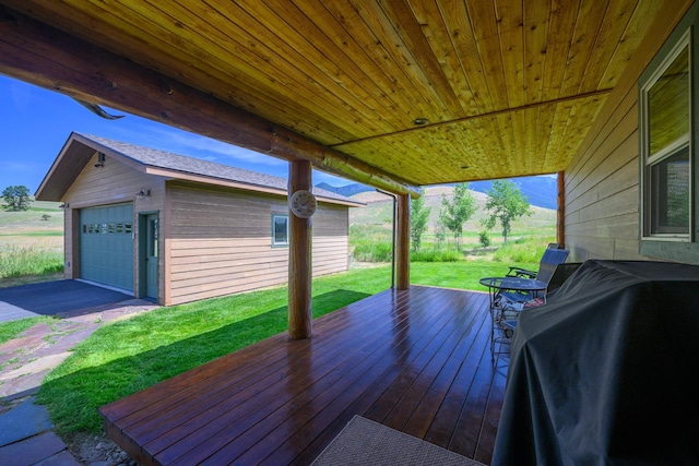 192 Leonard Ln, Eureka, MT 59917 - deck with grilling area, a yard, a detached garage, and an outbuilding