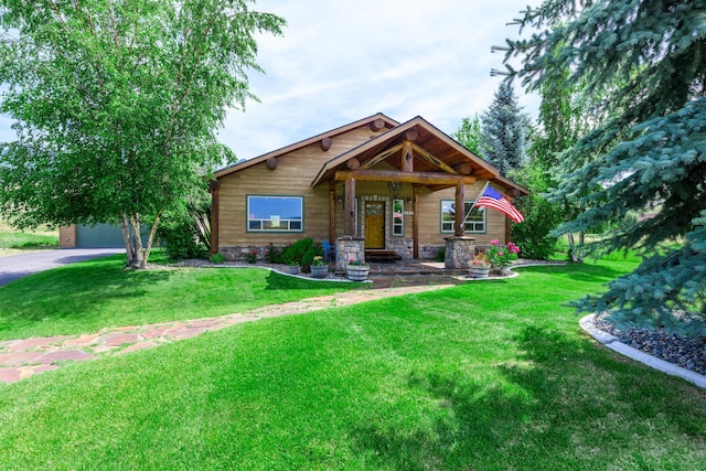 192 Leonard Ln, Eureka, MT 59917 - view of front of home featuring a front yard, a garage, a porch, and asphalt driveway