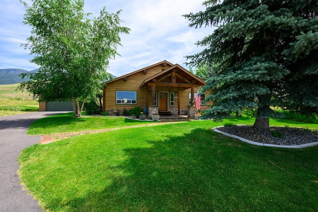 192 Leonard Ln, Eureka, MT 59917 - view of front facade featuring a front lawn, a porch, and driveway