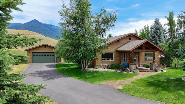 192 Leonard Ln, Eureka, MT 59917 - view of front of house featuring a mountain view, a front lawn, and driveway