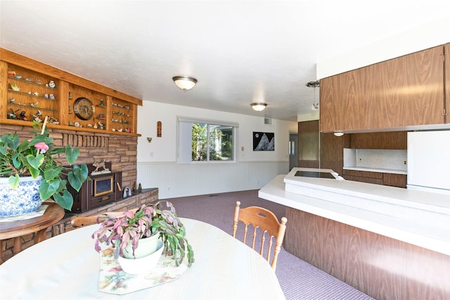 232 Kurtz Ln, Hamilton, MT 59840 - carpeted dining area with a fireplace and a wainscoted wall