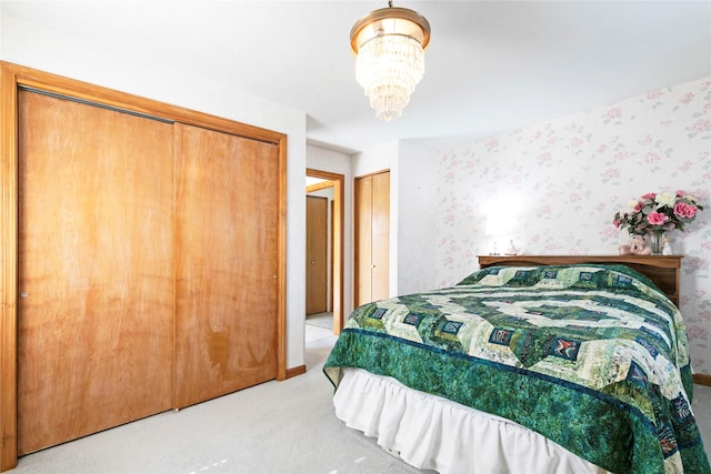 232 Kurtz Ln, Hamilton, MT 59840 - bedroom featuring carpet, a chandelier, multiple closets, and wallpapered walls