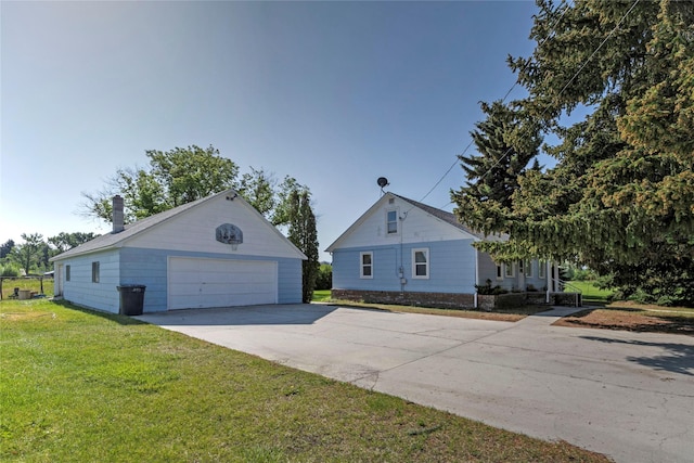 232 Kurtz Ln, Hamilton, MT 59840 - view of property exterior with an outbuilding, a detached garage, and a yard