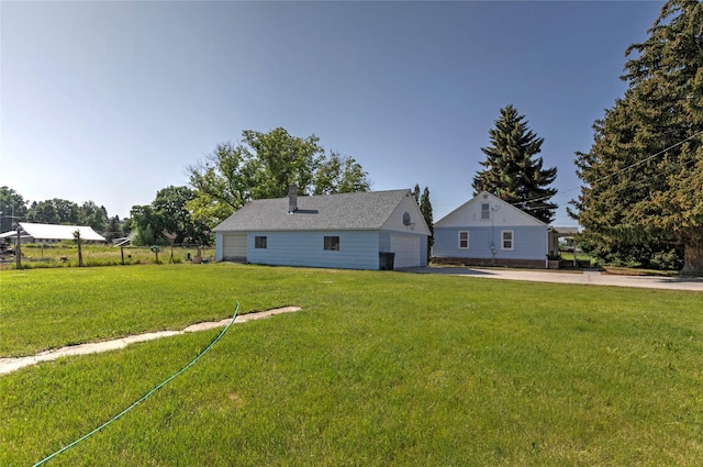 232 Kurtz Ln, Hamilton, MT 59840 - rear view of house featuring a yard, a chimney, and a detached garage