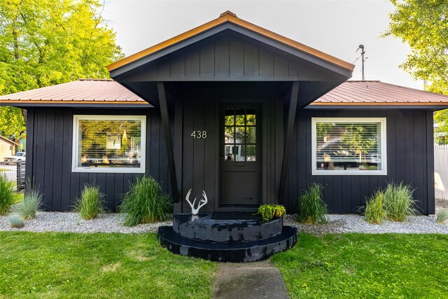 438 Somers Ave, Whitefish, MT 59937 - view of front of property featuring a metal roof, a front lawn, and board and batten siding