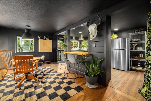 438 Somers Ave, Whitefish, MT 59937 - dining room with light wood-style floors and a textured ceiling