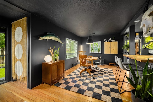 438 Somers Ave, Whitefish, MT 59937 - dining area featuring a textured ceiling and light wood-style flooring