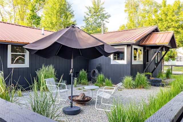 438 Somers Ave, Whitefish, MT 59937 - rear view of house with a metal roof, a fire pit, and a patio
