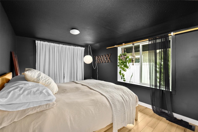 438 Somers Ave, Whitefish, MT 59937 - bedroom with wood finished floors and a textured ceiling