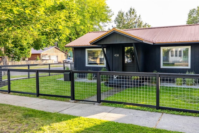 438 Somers Ave, Whitefish, MT 59937 - single story home featuring a fenced front yard, a metal roof, and board and batten siding