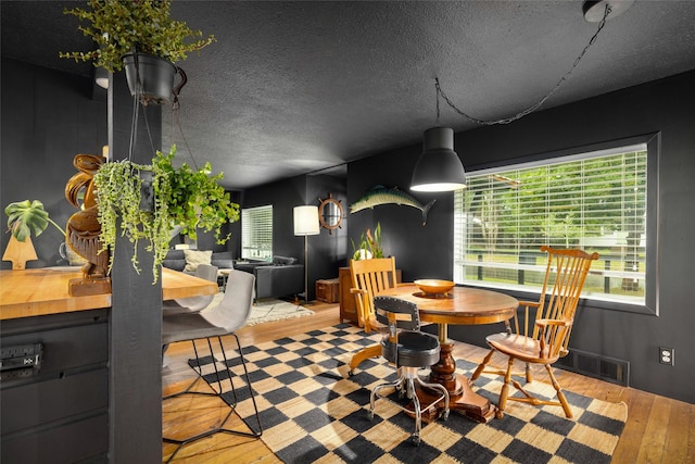 438 Somers Ave, Whitefish, MT 59937 - dining space featuring wood-type flooring and a textured ceiling