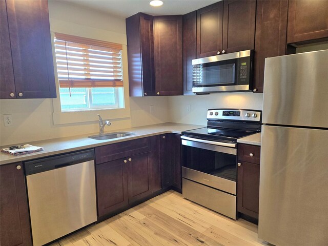 138 Jewel Basin Ct, Bigfork, MT 59911 - kitchen with stainless steel appliances, light wood-style floors, light countertops, dark brown cabinets, and recessed lighting