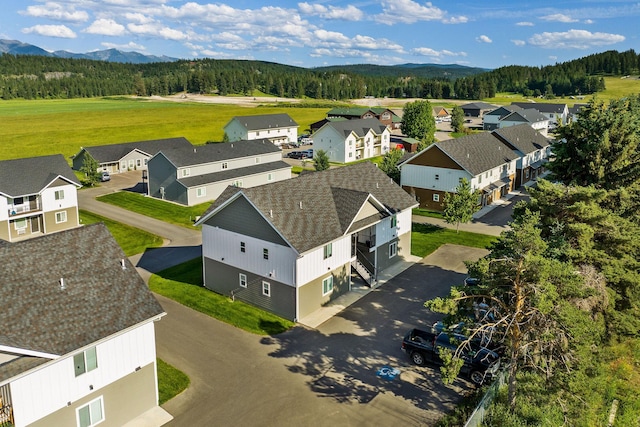 138 Jewel Basin Ct, Bigfork, MT 59911 - aerial perspective of suburban area featuring a heavily wooded area and a mountain backdrop