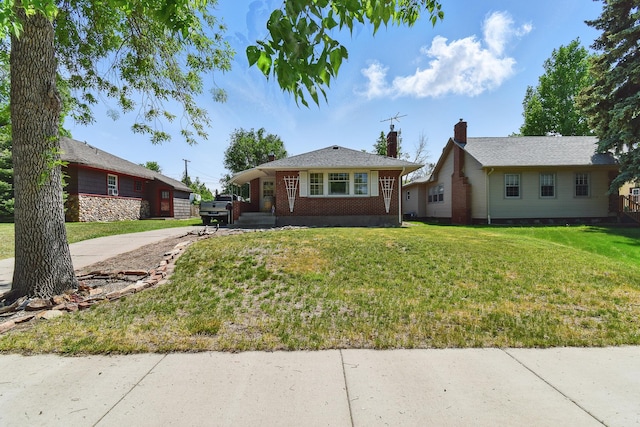 3120 1st Ave N, Great Falls, MT 59401 - bungalow-style home with driveway, brick siding, a front yard, and a chimney