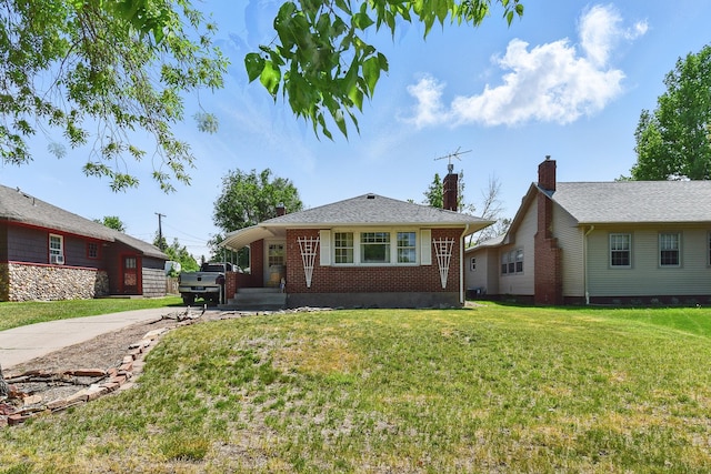 3120 1st Ave N, Great Falls, MT 59401 - bungalow-style home with brick siding, a front yard, a chimney, and driveway