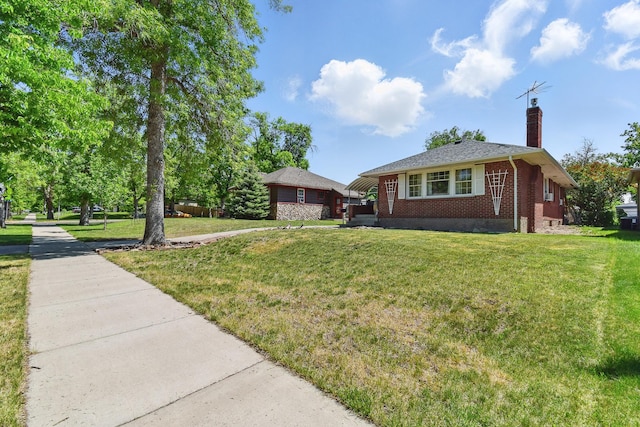 3120 1st Ave N, Great Falls, MT 59401 - view of front of home with brick siding, a chimney, and a front yard