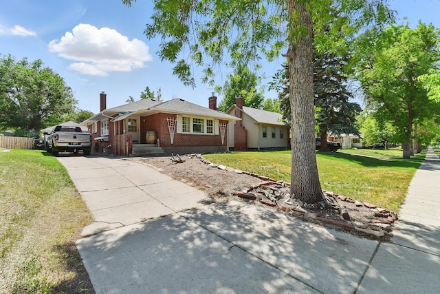3120 1st Ave N, Great Falls, MT 59401 - view of front of property with brick siding, concrete driveway, and a chimney