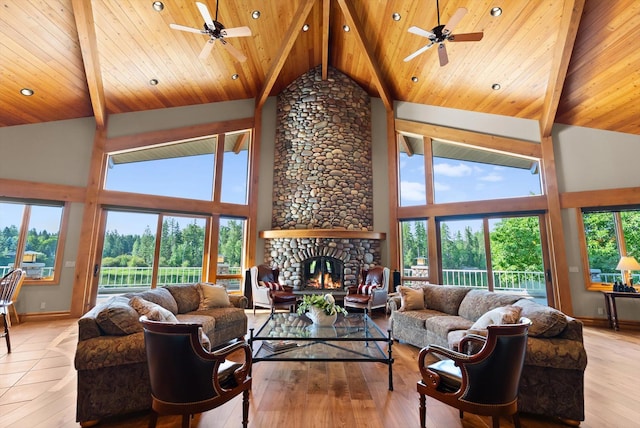 639 Three Eagle Ln, Bigfork, MT 59911 - living room with ceiling fan, high vaulted ceiling, a fireplace, plenty of natural light, and a wooden ceiling with exposed beams