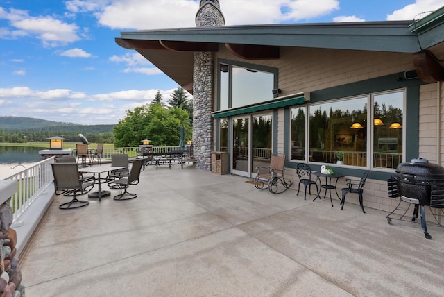 639 Three Eagle Ln, Bigfork, MT 59911 - view of patio / terrace with grilling area and a water view
