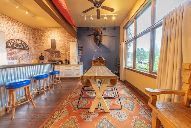 439 Osborn Ave Unit 115, Bigfork, MT 59911 - dining room featuring track lighting, hardwood / wood-style flooring, a ceiling fan, and brick wall