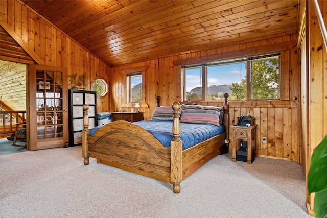 487 Hudson Ln, Victor, MT 59875 - carpeted bedroom featuring lofted ceiling, wood walls, a mountain view, and wooden ceiling