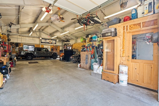 487 Hudson Ln, Victor, MT 59875 - garage featuring a garage door opener and a workshop area