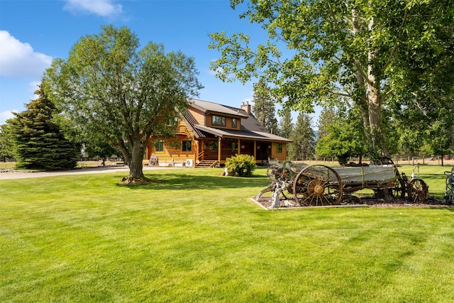 487 Hudson Ln, Victor, MT 59875 - log home with a chimney, log exterior, a front lawn, and a metal roof