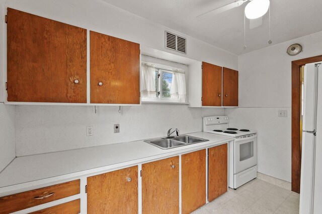1307 4th St W, Kalispell, MT 59901 - kitchen with white appliances, brown cabinetry, light countertops, and a ceiling fan