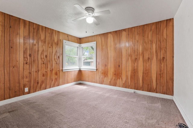 1307 4th St W, Kalispell, MT 59901 - empty room with a ceiling fan, carpet, and wood walls