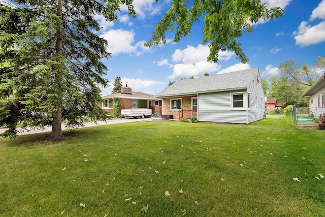 1307 4th St W, Kalispell, MT 59901 - rear view of property with brick siding and a chimney