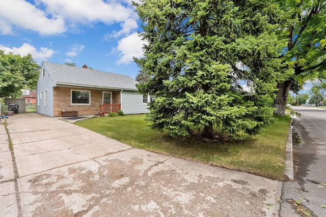 1307 4th St W, Kalispell, MT 59901 - view of front facade with a chimney, a front lawn, driveway, and roof with shingles