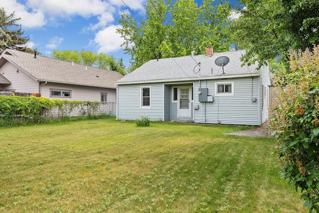 1307 4th St W, Kalispell, MT 59901 - rear view of house featuring a chimney and roof with shingles