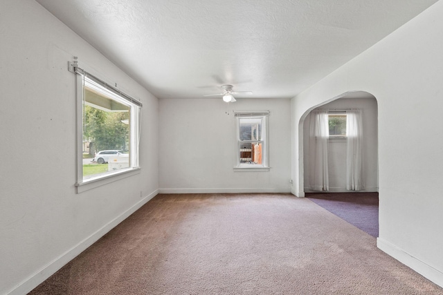 1307 4th St W, Kalispell, MT 59901 - unfurnished room with carpet floors, arched walkways, plenty of natural light, and ceiling fan