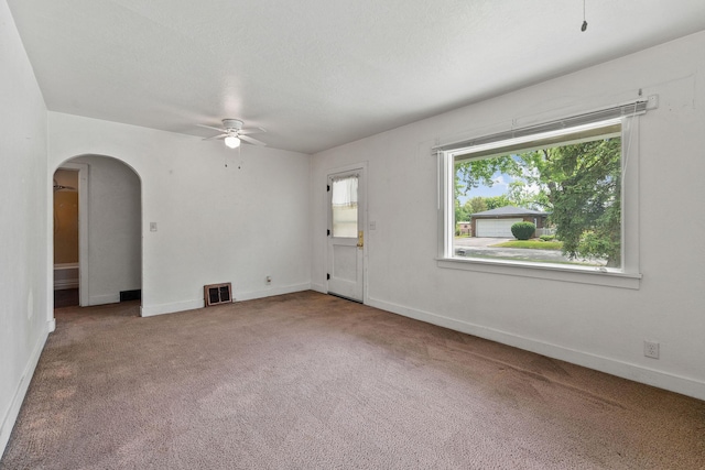 1307 4th St W, Kalispell, MT 59901 - carpeted empty room with ceiling fan and arched walkways
