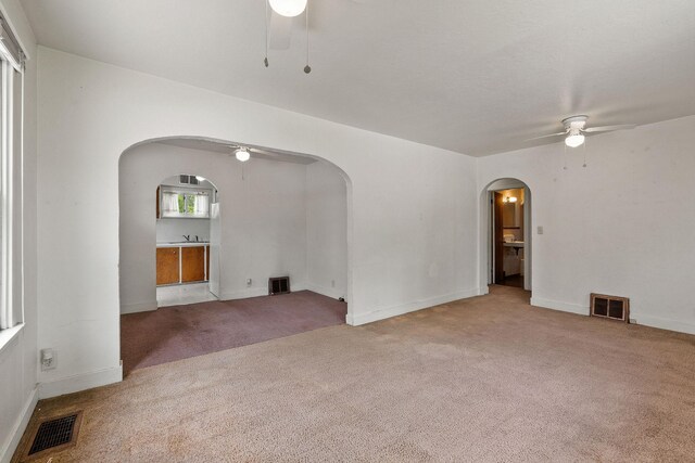 1307 4th St W, Kalispell, MT 59901 - carpeted spare room with a ceiling fan and arched walkways