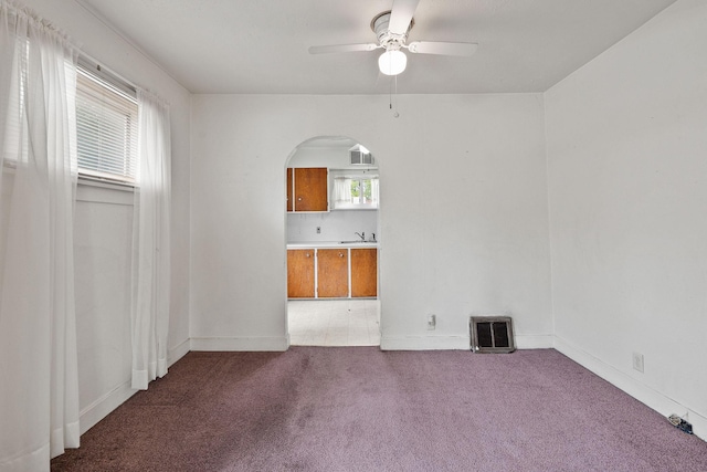 1307 4th St W, Kalispell, MT 59901 - unfurnished room featuring carpet, ceiling fan, arched walkways, and plenty of natural light