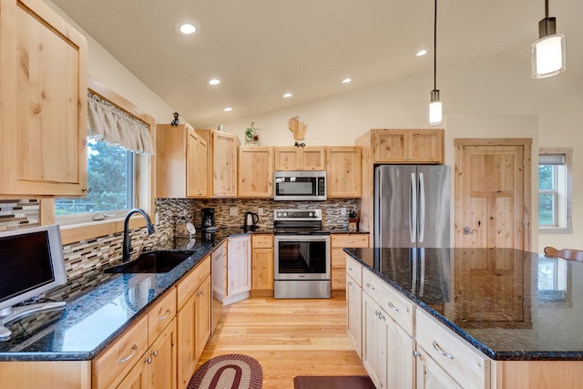 109 Como Vista Ln, Hamilton, MT 59840 - kitchen with stainless steel appliances, light brown cabinetry, light wood finished floors, lofted ceiling, and recessed lighting
