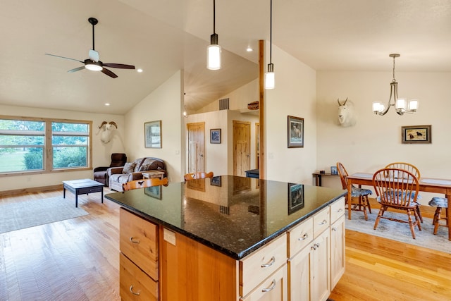 109 Como Vista Ln, Hamilton, MT 59840 - kitchen with light wood-style floors, lofted ceiling, ceiling fan, hanging light fixtures, and a chandelier