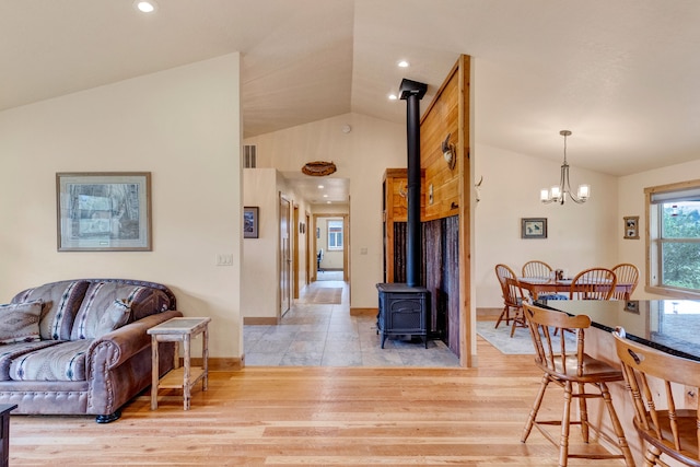 109 Como Vista Ln, Hamilton, MT 59840 - living area with a wood stove, vaulted ceiling, light wood-style floors, a chandelier, and recessed lighting